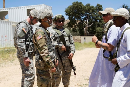 U.S. Army Reserve 1st Lt. Dung Nguyen, Chaplain, 371st Combat Sustainment Support Battalion,Riverside, Calif., builds rapport with villagers, portrayed by costumed role players, at a senior leaderengagement scenario during Combat Support Training Exercise 91-16-02, Fort Hunter Liggett, Calif.,June 16, 2016. As the largest U.S. Army Reserve training exercCSTX 91-16-02ise, CSTX 91-16-02 provides Soldierswith unique opportunities to sharpen their technical and tactical skills in combat-like conditions. (U.S.Army photo by Spc. Fatima Konteh, 367th Mobile Public Affairs Detachment)