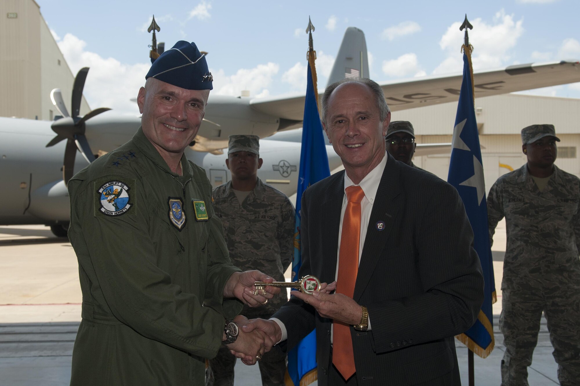 Gary Fletcher, Mayor of Jacksonville, Ark., presents a key to the city to Gen. Carlton D. Everhart II, Air Mobility Command commander, at Little Rock Air Force Base, Ark., June 20, 2016. Everhart visited Little Rock AFB to deliver the final C-130J to the 19th Airlift Wing from Lockheed Martin. (U.S. Air Force photo/Senior Airman Harry Brexel)