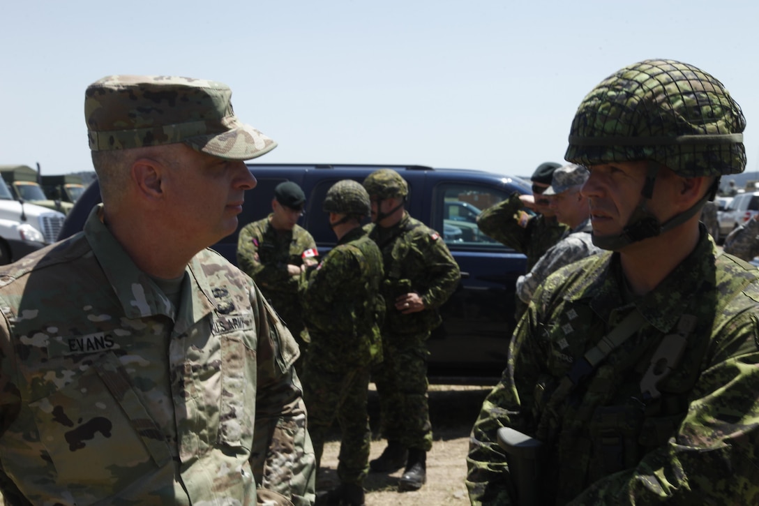 Brig. Gen. Thomas Evans, of the 80th Training Command United States Army Reserve, speaks with Cpt. Brad Young, of 41 Canadian Brigade Group, at forward operating base Custer, during Golden Coyote, June 17, 2016.  The Golden Coyote exercise is a three-phase, scenario-driven exercise conducted in the Black Hills of South Dakota and Wyoming, which enables commanders to focus on mission essential task requirements, warrior tasks and battle drills. (U.S. Army photo by Spc. Mitchell Murphy/Released)
