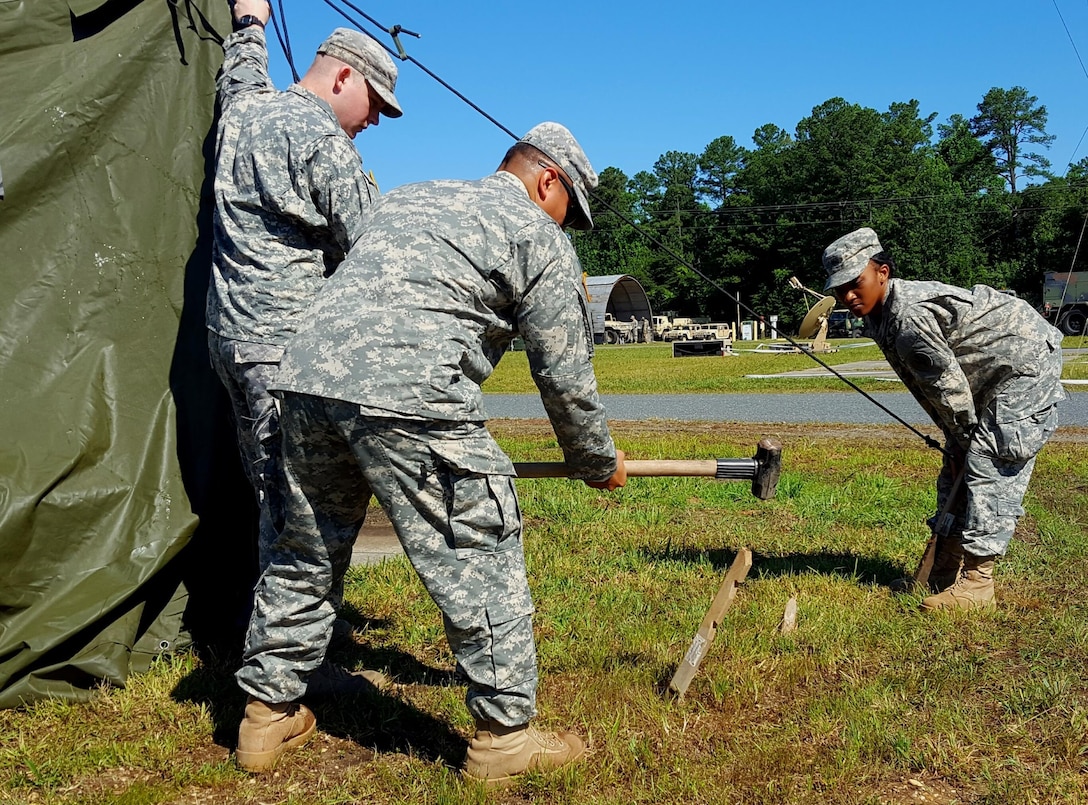 Fort A.P. Hill, Va. — 1st Lt. Richard Nora of Gurnee, Ill., left, Sgt. Oscar Sevilla of Chicago, center, and Pvt. Taliyah Johnson of Gary, Ind., reset their tent. The Army Reserve 956th Movement Control Team’s tent knocked down after a severe storm struck Archer Camp at Fort A.P. Hill, Va., on June 17. The 956th MCT were taking part in Quartermaster Liquid Logistics Exercise 2016. (U.S. Army photo by Sgt. 1st Class Claude Dixon, 372nd Mobile Public Affairs Detachment)