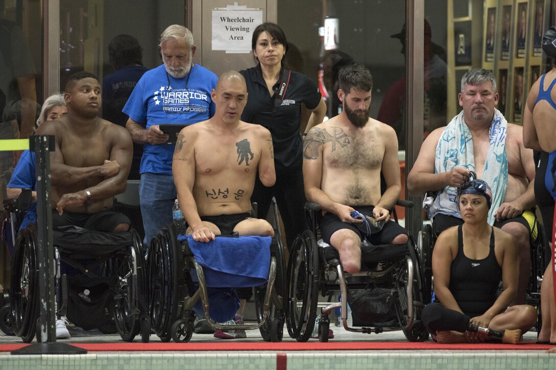 Seated from left, athletes Ryan Major, Matthew Lammers, Stefan LeRoy, all Army veterans; Army 1st Lt. Chris Parks; and veteran Ana Manciaz watch a swimming event during the 2016 Department of Defense Warrior Games at the U.S. Military Academy in West Point, N.Y., June 20, 2016. DoD photo by Roger Wollenberg