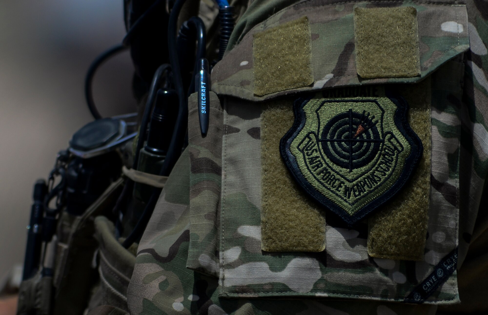 A Joint Terminal Attack Controller wears the covetable United States Weapons School Graduate Patch during Joint Forcible Entry Exercise on the Nevada Test and Training Range, June 16, 2016.  JFEX tests participants' ability to synchronize aircraft movements from geographically-separated bases, command large formations of dissimilar aircraft in high threat airspace, and tactically deliver and recover combat forces via air drops and combat landings on an unimproved landing strip. (U.S. Air Force photo by Airman 1st Class Kevin Tanenbaum)