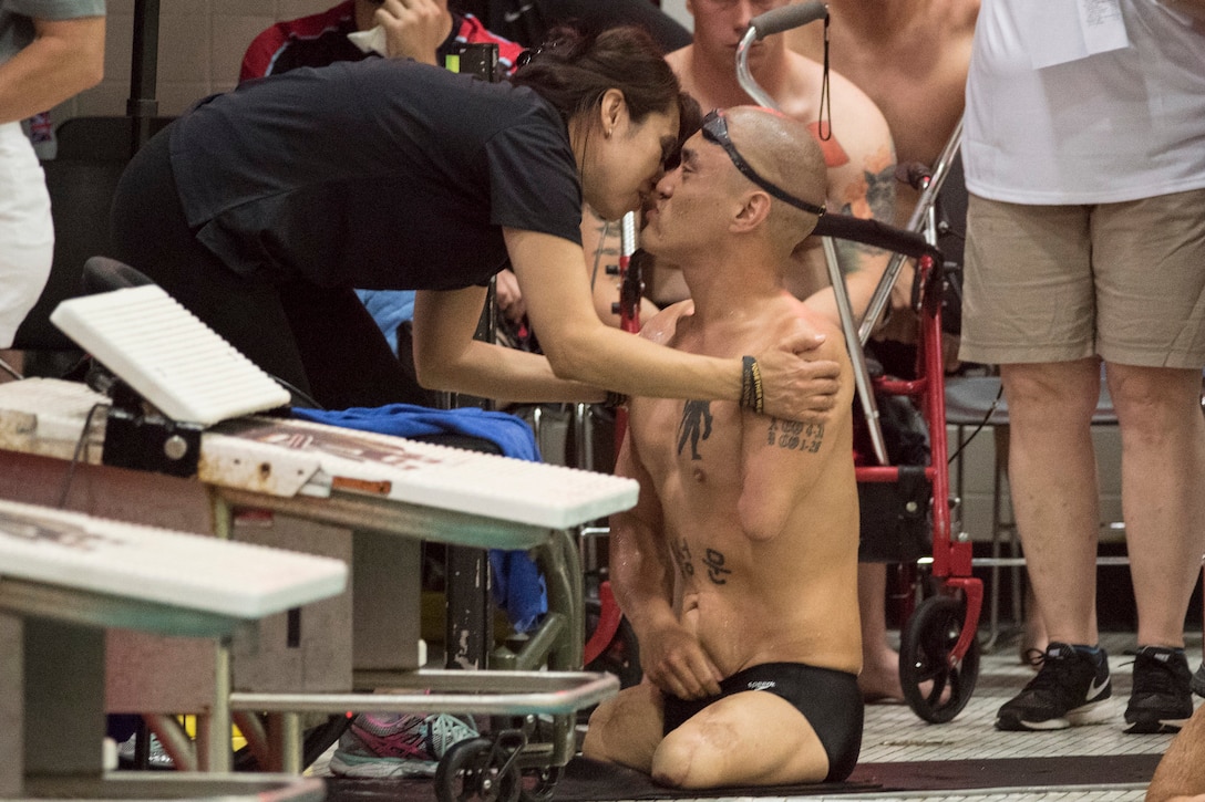 Army veteran Matthew Lammers gets a kiss from his wife, Alescia, after competing in a backstroke event during the 2016 Department of Defense Warrior Games at the U.S. Military Academy in West Point, N.Y., June 20, 2016. DoD photo by Roger Wollenberg