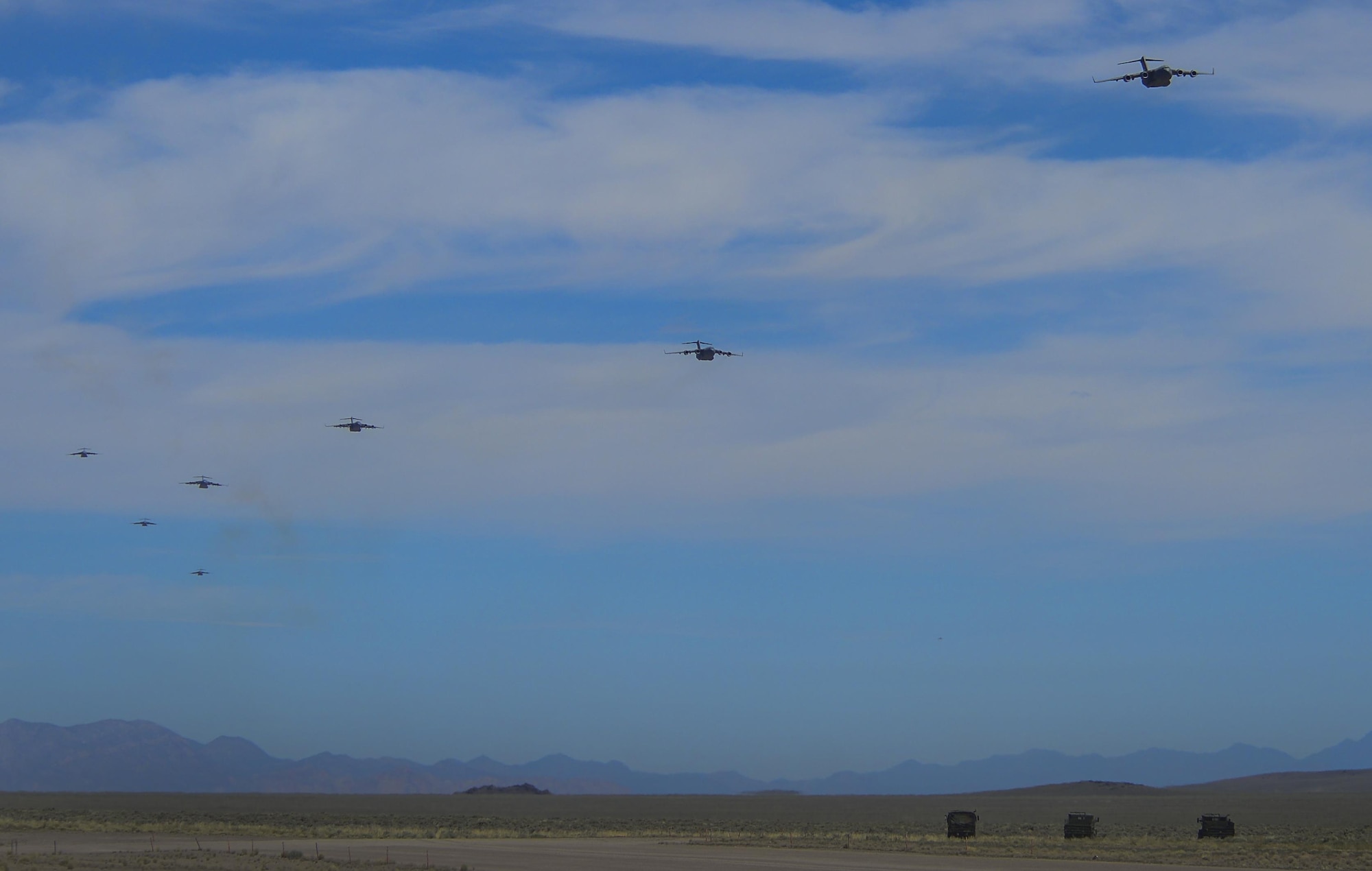 Multiple C-130 Hercules, assigned to the 29th Weapons Squadron, Little Rock Air Force Base, Arkansas, fly in formation over the Nevada Test and Training Range during the Joint Forcible Entry Exercise portion of the United States Air Force Weapons School Advanced Integration, June 16, 2016. The exercise is the U.S. Air Force Weapons School biannual collaboration that, according to an Air Force fact sheet, exercises the Air Force's ability to tactically deliver and recover combat forces via air drops and combat landings in a contested environment. (U.S. Air Force photo by Airman 1st Class Kevin Tanenbaum)