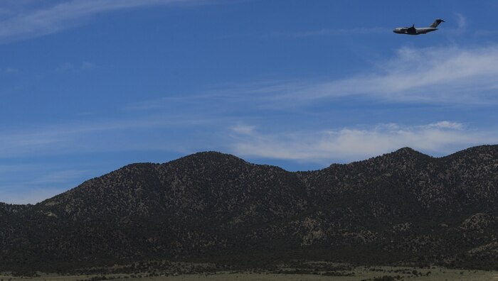 A C-130 Hercules, assigned to the 29th Weapons Squadron, Little Rock Air Force Base, Arkansas, flies over the mountains of the Nevada Test and Training Range during the Joint Forcible Entry Exercise portion of the United States Air Force Weapons School Advanced Integration, June 16, 2016. C-130s are capable of using unprepared runways for takeoffs and landings. (U.S. Air Force photo by Airman 1st Class Kevin Tanenbaum)