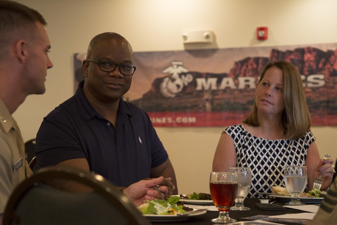 Marc Malone and Angie Davis speak with a Marine during a welcome address at the Holiday Inn Express in Dumfries, Va., June 20 as part of the 2016 Key Leaders and Educators Workshop. Marines welcomed approximately 40 educators from states west of the Mississippi River and explained what they should expect during the workshop. Until the workshop ends June 24, educators will experience a flight in an MV-22 Osprey, infantry patrolling and many other events to experience firsthand what goes into making Marine officers. The workshop creates a mutually beneficial and meaningful relationship between educators and the Marine Corps where key leaders and educators can share knowledge about the Corps to students interested in Marine officer programs. Malone is an academic advisor for Purdue University in West Lafayette, Indiana. Davis is a skating instructor for University of Notre Dame in South Bend, Indiana.