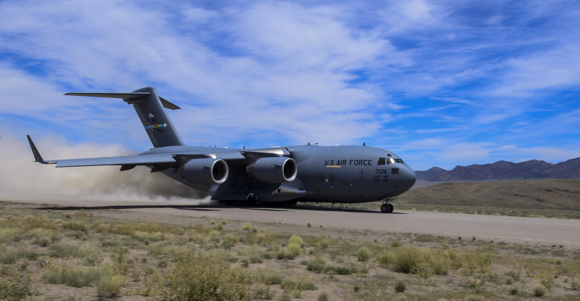 A C-17 Globemaster III, assigned to the 17th Weapons Squadron, Nellis Air Force Base, Nevada, lands on an airstrip in the Nevada Test and Training Range during Joint Forcible Entry Exercise, June 16, 2016. JFEX is a U.S. Air Force Weapons School large-scale air mobility exercise in which participants plan and execute a complex air-land operation in a simulated contested battlefield. (U.S. Air Force photo by Airman 1st Class Kevin Tanenbaum)
