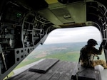 A reservist looks out over Central Pa. during an early morning Chinook flight from New Cumberland to Fort Indiantown Gap as part of a Reserve training mission. 