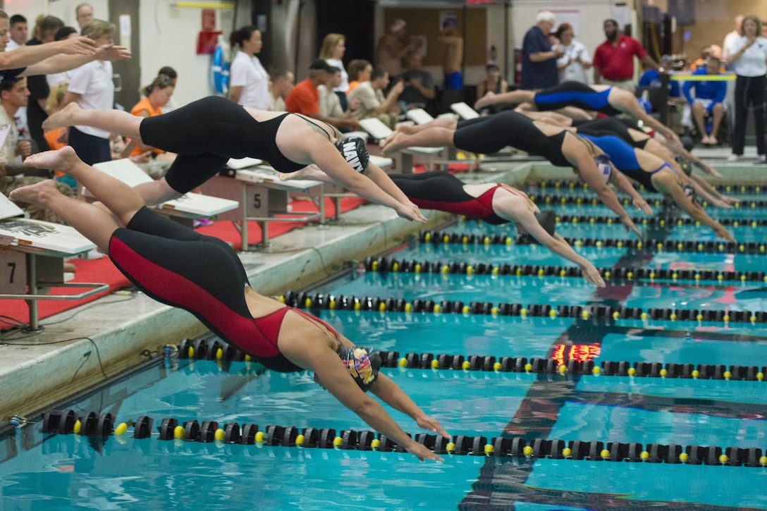 Athletes dive into the water to compete in a swimming event during the 2016 Department of Defense Warrior Games at the U.S. Military Academy in West Point, N.Y., June 20, 2016. DoD photo by Roger Wollenberg