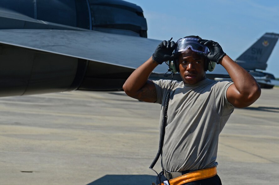 U.S. Air Force Senior Airman D’Andre Love, 20th Aircraft Maintenance Squadron tactical aircraft maintainer, adjusts his goggles after marshalling an F-16CM Fighting Falcon at Shaw Air Force Base, S.C., June 21, 2016. Airmen assigned to the 20th AMXS work around the clock to keep Shaw’s 76 F-16s mission-ready and deployable. (U.S. Air Force photo by Airman 1st Class Christopher Maldonado)