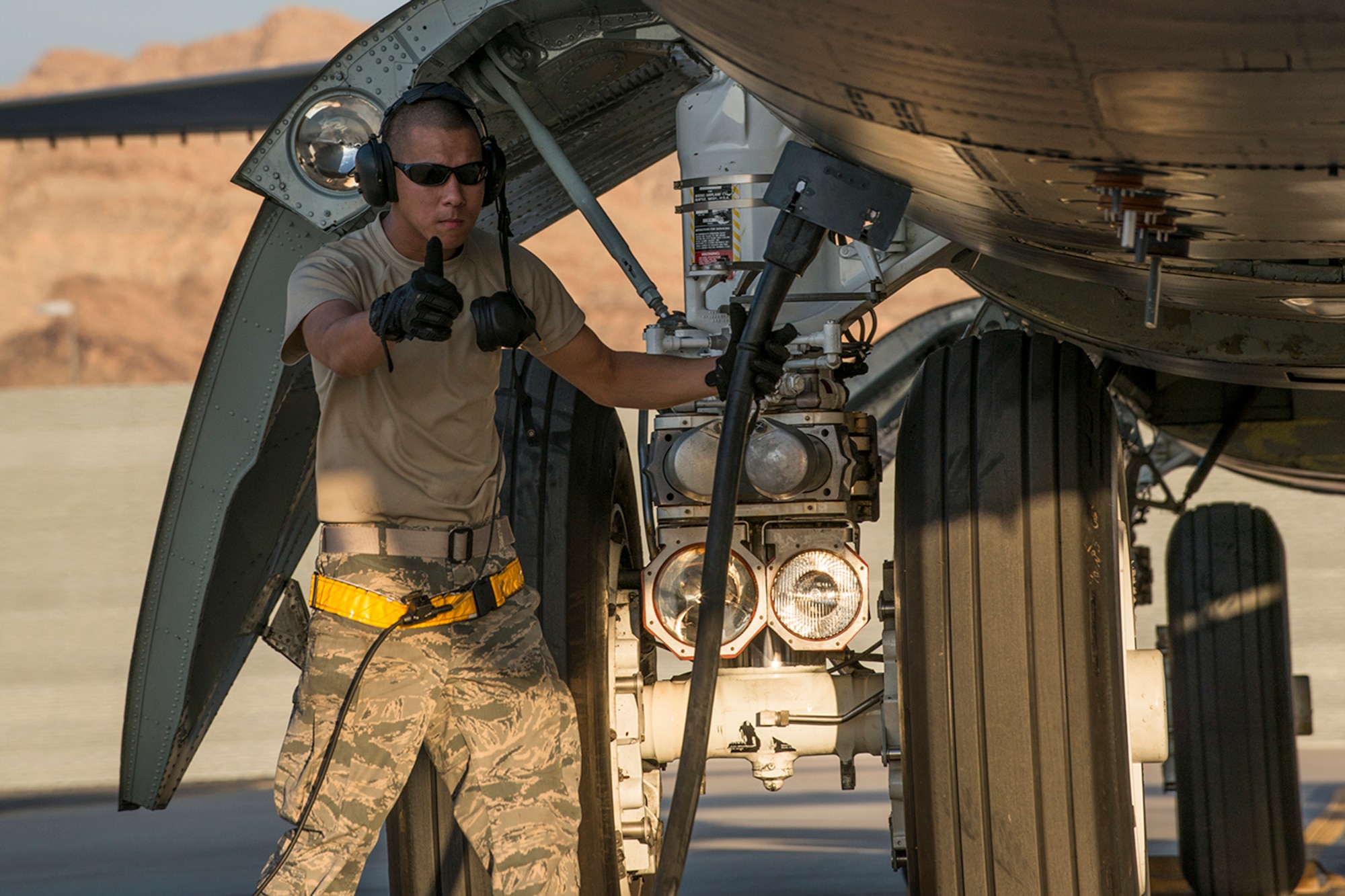 U.S. Air Force Airman First Class Guillermo Tomey, a 11th Aircraft Maintenance Unit crew chief, gives the thumbs up to remove external power from a B-52H Stratofortress prior to a mission on June 8, 2016, Nellis Air Force Base, Nev. Tomey is among 45 Active Duty and Air Force Reserve maintenance personnel on temporary duty at Nellis in support of the 340th Weapons Squadron. (U.S. Air Force photo by Master Sgt. Greg Steele/Released)