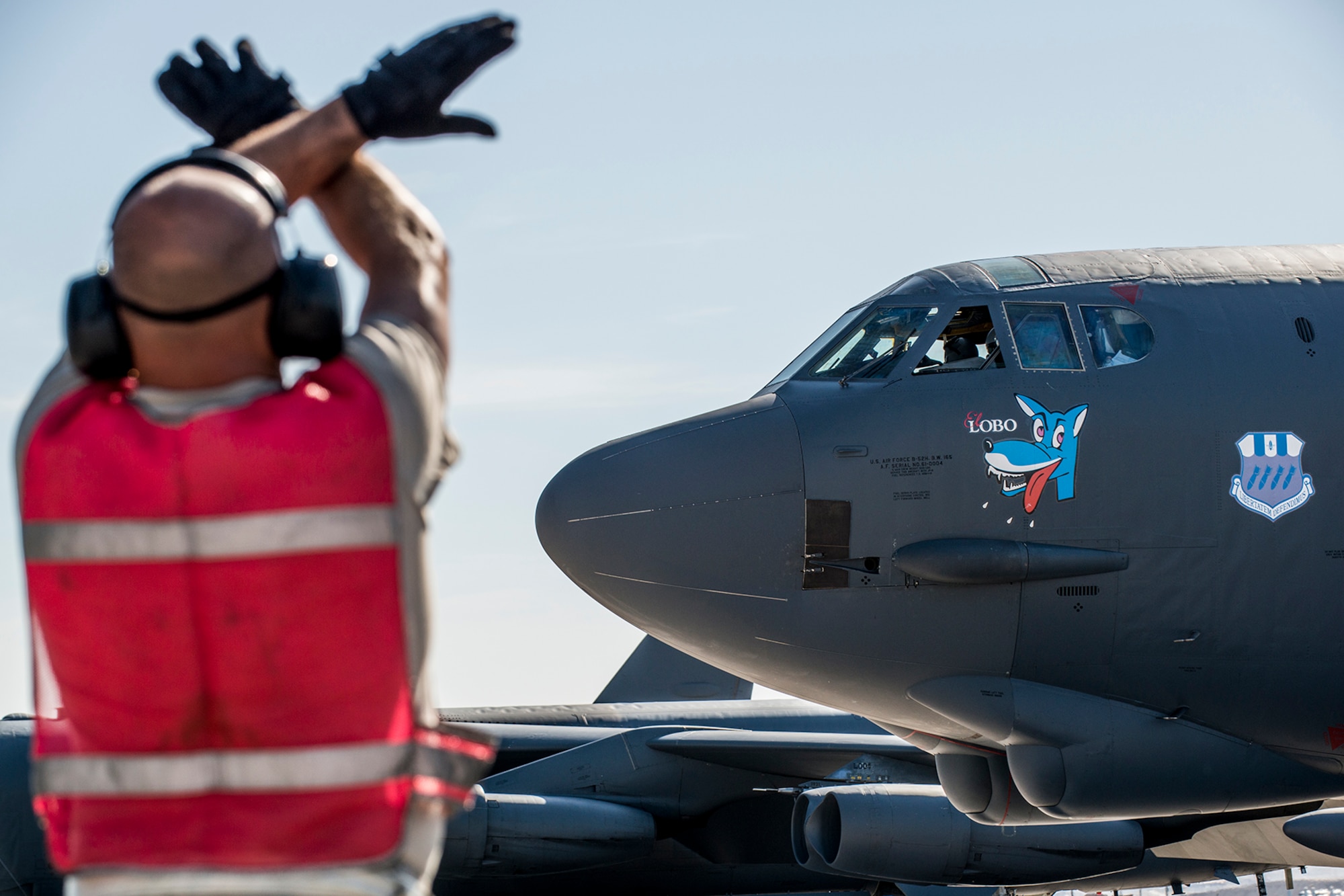 U.S. Air Force Tech. Sgt. James Spencer, a 307th Aircraft Maintenance Squadron crew chief, gives the “hold the breaks” symbol to the pilot of a B-52H Stratofortress before it takes off on for a mission on June 8, 2016, Nellis Air Force Base, Nev. Spencer is among 45 Active Duty and Air Force Reserve maintenance personnel on temporary duty at Nellis in support of the 340th Weapons Squadron. (U.S. Air Force photo by Master Sgt. Greg Steele/Released)