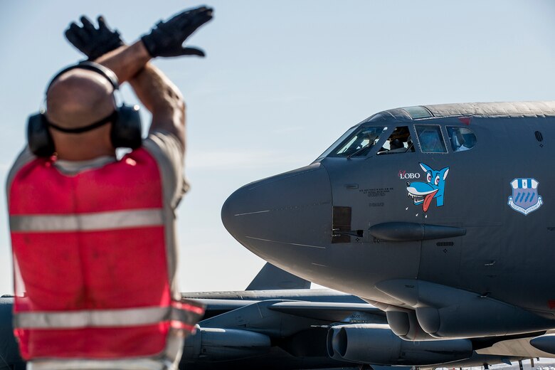 U.S. Air Force Tech. Sgt. James Spencer, a 307th Aircraft Maintenance Squadron crew chief, gives the “hold the breaks” symbol to the pilot of a B-52H Stratofortress before it takes off on for a mission on June 8, 2016, Nellis Air Force Base, Nev. Spencer is among 45 Active Duty and Air Force Reserve maintenance personnel on temporary duty at Nellis in support of the 340th Weapons Squadron. (U.S. Air Force photo by Master Sgt. Greg Steele/Released)