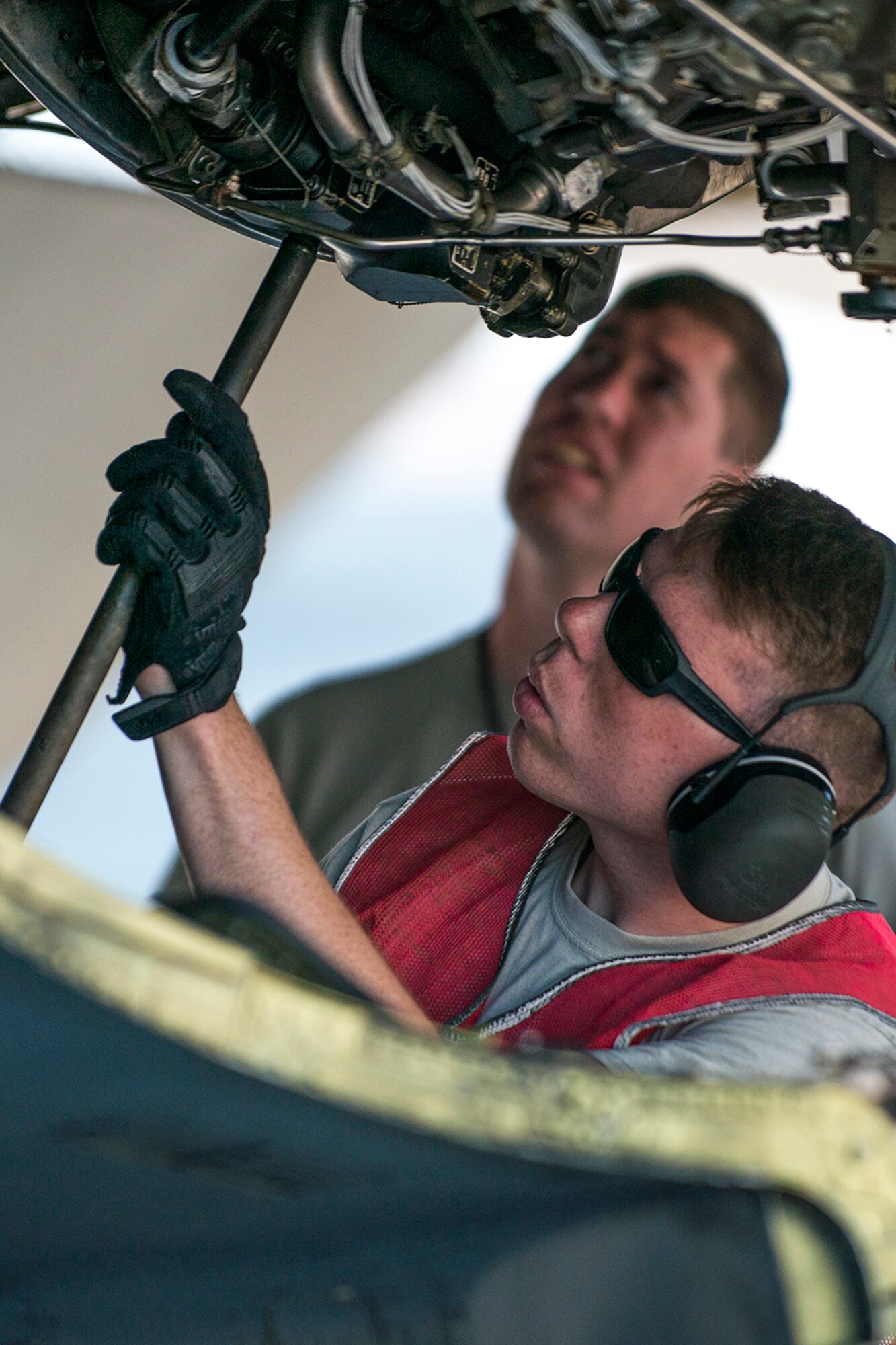 U.S. Air Force Airman First Class Jacob Lieuallen, a 11th Aircraft Maintenance Unit crew chief, installs a brace on the engine cowling of a B-52H Stratofortress in preparation for maintenance on June 8, 2016, Nellis Air Force Base, Nev. Lieuallen is among 45 Active Duty and Air Force Reserve maintenance personnel on temporary duty at Nellis in support of the 340th Weapons Squadron. (U.S. Air Force photo by Master Sgt. Greg Steele/Released)