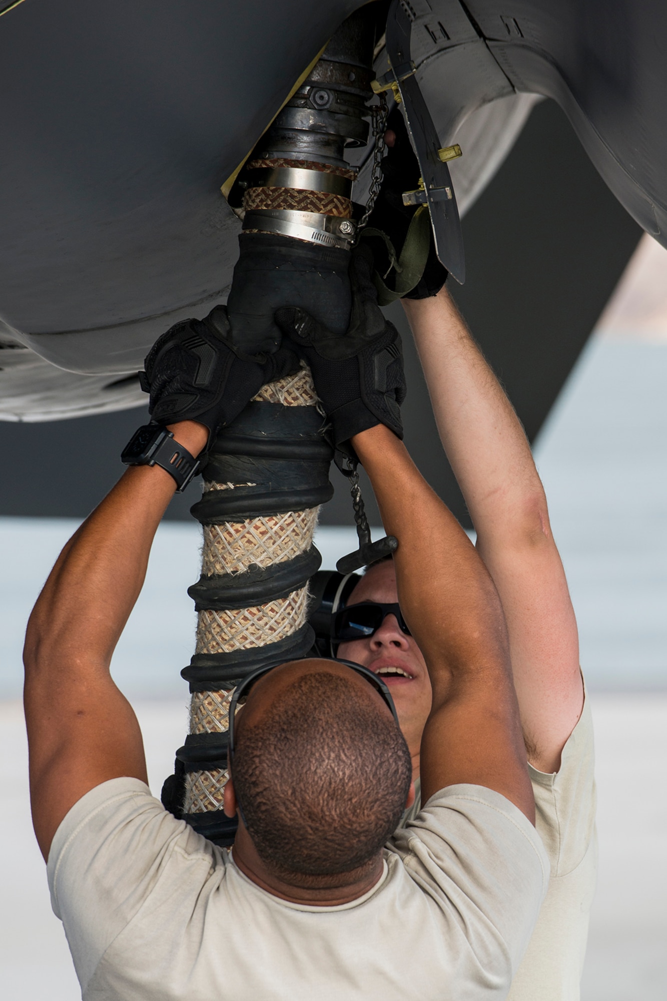 U.S. Air Force Airmen unhook a bleed air hose from the engine of a B-52H Stratofortress before a mission on June 8, 2016, Nellis Air Force Base, Nev. The Airmen are among 45 Active Duty and Air Force Reserve maintenance personnel on temporary duty at Nellis in support of the 340th Weapons Squadron. (U.S. Air Force photo by Master Sgt. Greg Steele/Released)