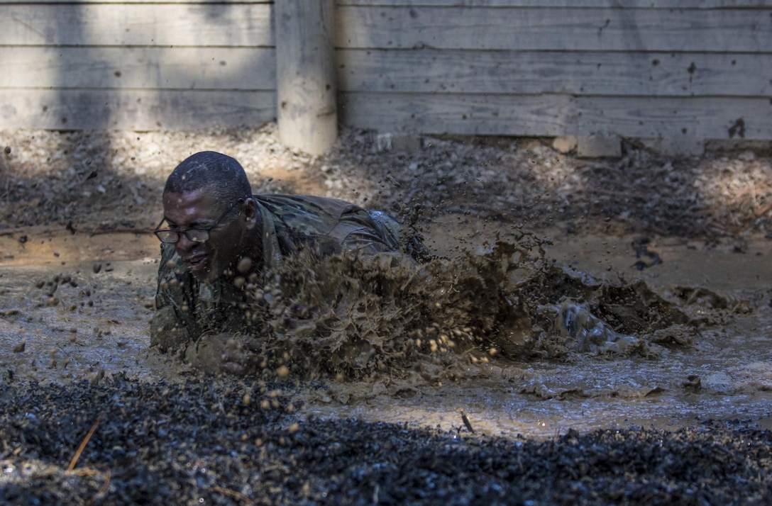 Leading by example, drill sergeant candidates at the United States Army Drill Sergeant Academy located at Fort Jackson, S.C., tackle the mud pit obstacle on the fit-to-win endurance obstacle course, June 17. Candidates from the U.S. Army, Army Reserve and National Guard spend 63 training days in the course preparing to become drill sergeants for the Army's four basic combat training posts. (U.S. Army photo by Sgt. 1st Class Brian Hamilton/ released)