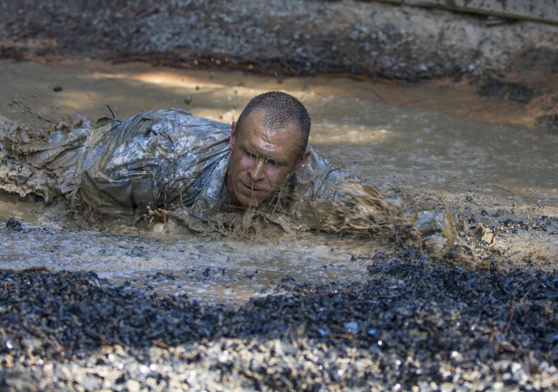 Leading by example, drill sergeant candidates at the United States Army Drill Sergeant Academy located at Fort Jackson, S.C., tackle the mud pit obstacle on the fit-to-win endurance obstacle course, June 17. Candidates from the U.S. Army, Army Reserve and National Guard spend 63 training days in the course preparing to become drill sergeants for the Army's four basic combat training posts. (U.S. Army photo by Sgt. 1st Class Brian Hamilton/ released)