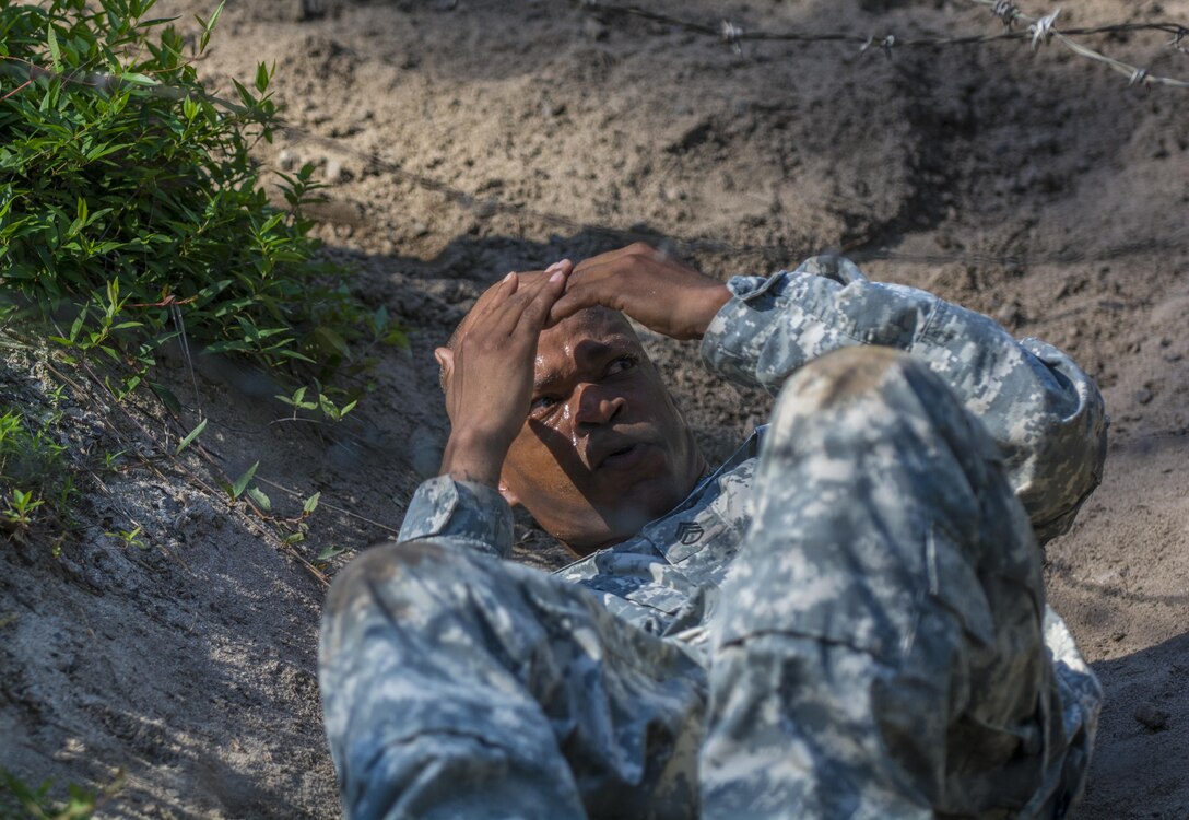 A drill sergeant candidate at the United States Army Drill Sergeant Academy located at Fort Jackson, S.C., negotiates the wire obstacle on the fit-to-win endurance obstacle course, June 17. Candidates from the U.S. Army, Army Reserve and National Guard spend 63 training days in the course preparing to become drill sergeants for the Army's four basic combat training posts. (U.S. Army photo by Sgt. 1st Class Brian Hamilton/ released)