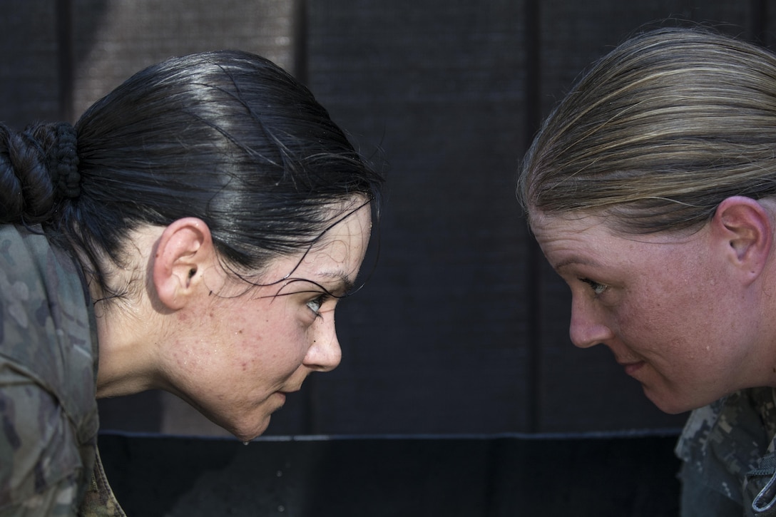 Drill sergeant candidates at the United States Army Drill Sergeant Academy located at Fort Jackson, S.C., take a moment to cool down in the arms immersion tank after negotiating the fit-to-win endurance obstacle course, June 17. Candidates from the U.S. Army, Army Reserve and National Guard spend 63 training days in the course preparing to become drill sergeants for the Army's four basic combat training posts. (U.S. Army photo by Sgt. 1st Class Brian Hamilton/ released)