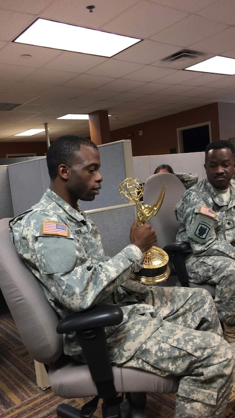 Spc. David Alexander of the 215th Mobile Public Affairs Detachment, U.S Army Reserve, holds an "Emmy" awarded to Rick Mickler during his time as a cameraman with ESPN. The son of a veteran, Rickler visted the 215th and shared insight from more than 25 years of experience in the broadcast journalism industry during a Joint workshop between the 241st MPAD, Louisiana National Guard and the 215th.