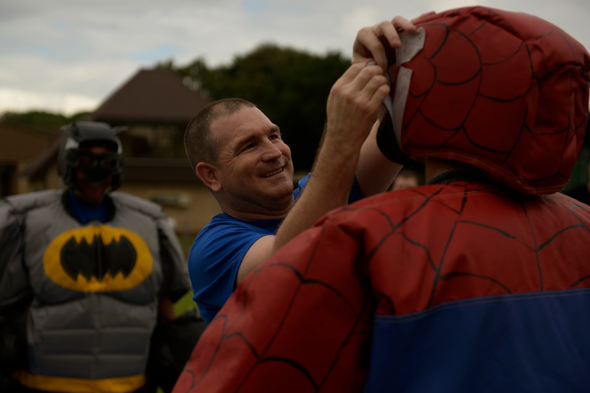 Master Sgt. Corey Quinn, 48th Communications Squadron first sergeant, helps a participant put on a Spiderman outfit during the second annual 48th Mission Support Group Olympics at Royal Air Force Lakenheath, England, June 16, 2016. The sumo wrestling competition is one of nine events pitting Airmen against each other as part of a friendly rivalry. (U.S. Air Force photo/ Airman 1st Class Abby L. Finkel)