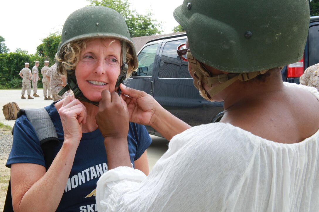 Anene Ejikeme assists Amy Stefan with a kevlar before they begin the Leadership Reaction Course at Officer Candidates School aboard Marine Corps Base Quantico, Va., June 21 for the 2016 Key Leaders and Educators Workshop. Until the workshop ends June 24, it includes events such as infantry patrolling, flight simulations and many others in order to provide educators a robust understanding of what goes into making Marine officers. The workshop creates a mutually beneficial relationship between educators and the Marine Corps where key leaders and educators can share knowledge about the Corps to students based on firsthand experience. Ejikeme is a history professor at Trinity University in Antonio, Texas. Stefan is a career coach from Montana State University in Bozeman, Mt.