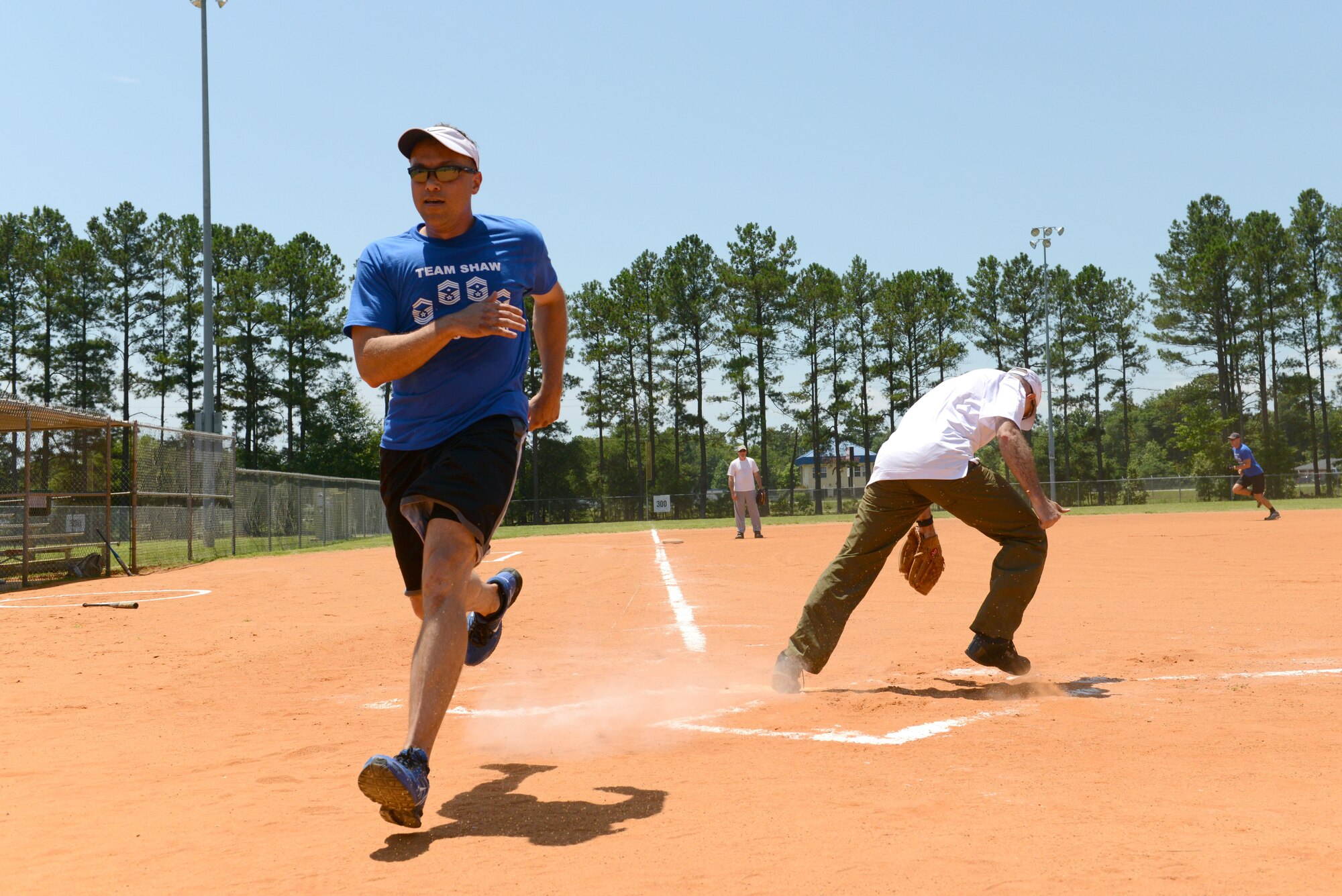 U.S. Air Force Chief Master Sgt. Richard Skrabak, 20th Comptroller Squadron superintendent, runs past home base during a chiefs vs. colonels softball game at Shaw Air Force Base, S.C., June 16, 2016. Colonels took on chiefs in a softball game to cultivate teamwork and improve morale. (U.S. Air Force photo by Airman 1st Class Destinee Dougherty)