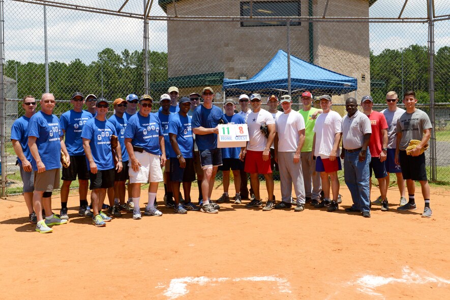 U.S. Air Force colonels and chief master sergeants who participated in a chiefs vs. colonels softball game pose for a group photo at Shaw Air Force Base, S.C., June 16, 2016. After seven innings, the chiefs won the ball game using teamwork to achieve a score of 11-8. (U.S. Air Force photo by Airman 1st Class Destinee Dougherty)
