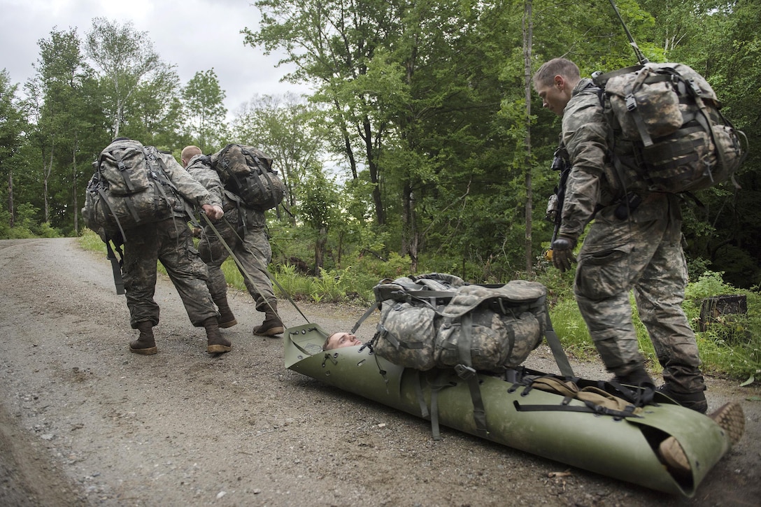 Soldiers drag a simulated wounded patient in an evacuation stretcher while participating in an exercise to assess and evacuate casualties at Camp Ethan Allen Training Site in Jericho, Vt., June 12, 2016. Air National Guard photo by Tech. Sgt. Sarah Mattison