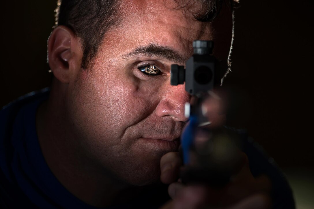 Air Force veteran Master Sgt. D. Reese Hines poses for a photo with a competition air rifle at the U.S. Military Academy in West Point, N.Y., June 19, 2016. Hines was named the event’s Ultimate Champion after winning a series of events. DoD photo by EJ Hersom