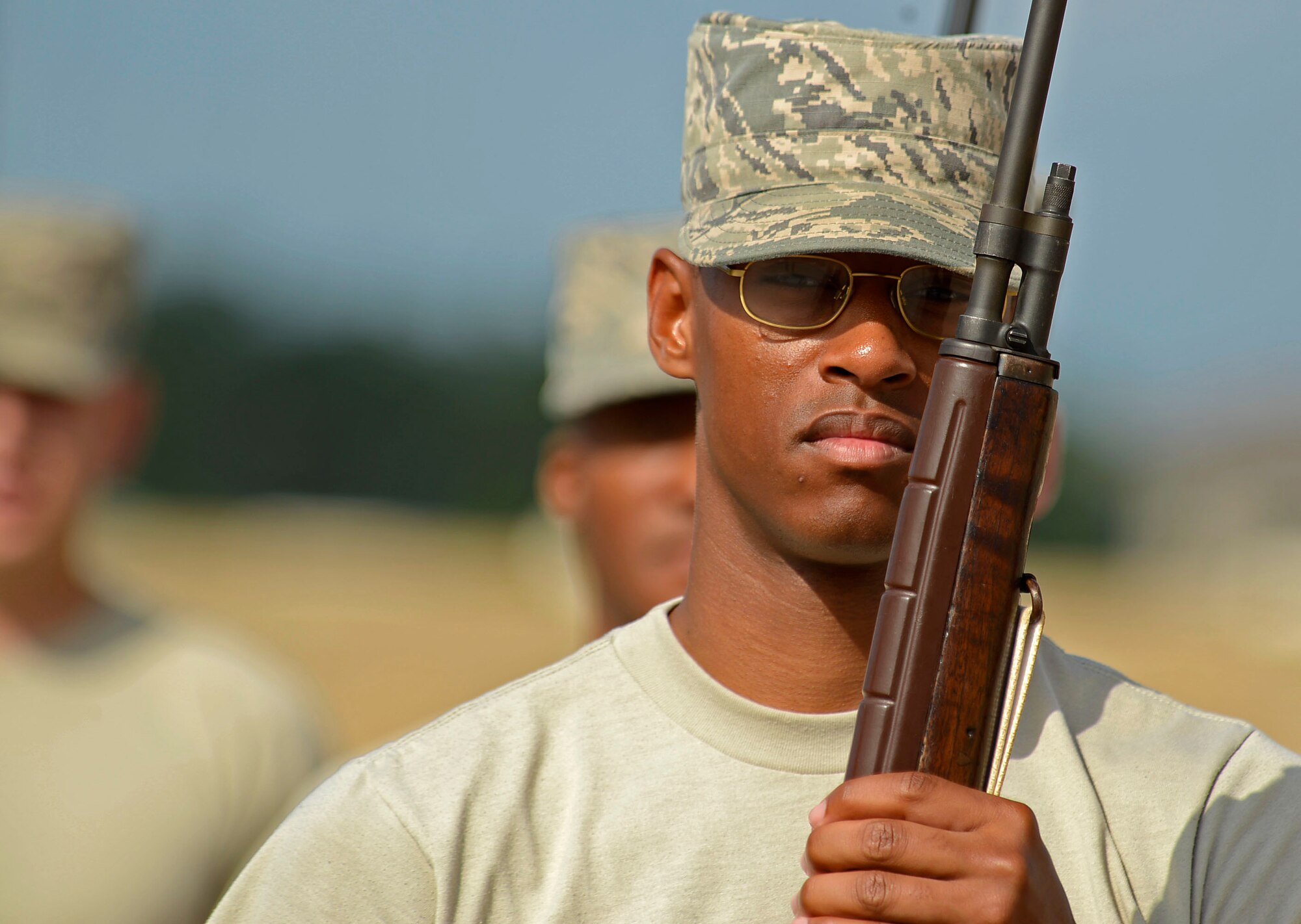 U.S. Air Force Airman 1st Class Larry Wallace, 20th Force Support Squadron honor guardsman, stands at attention after performing a drill movement during an open ranks with rifle inspection at Shaw Air Force Base, S.C., June 16, 2016. Members entering the Shaw honor guard train for two weeks before being allowed the opportunity to represent the base in ceremonies. (U.S. Air Force photo by Airman 1st Class Christopher Maldonado)