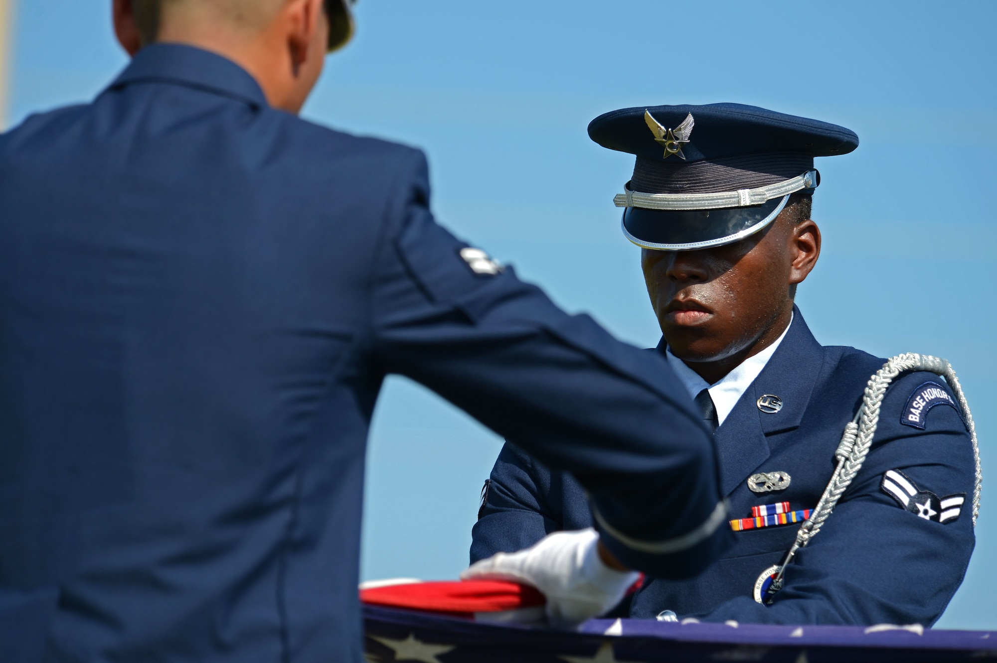 U.S. Air Force Airman 1st Class Dhaimiah Williams, 20th Force Support Squadron honor guardsman, folds a flag during a practice funeral detail at Shaw Air Force Base, S.C., June 17, 2016. Airmen assigned to the 20th FSS Honor Guard train almost six hours a day to ensure ceremonial procedures are executed with the utmost precision and sharpness. (U.S. Air Force photo by Airman 1st Class Christopher Maldonado)