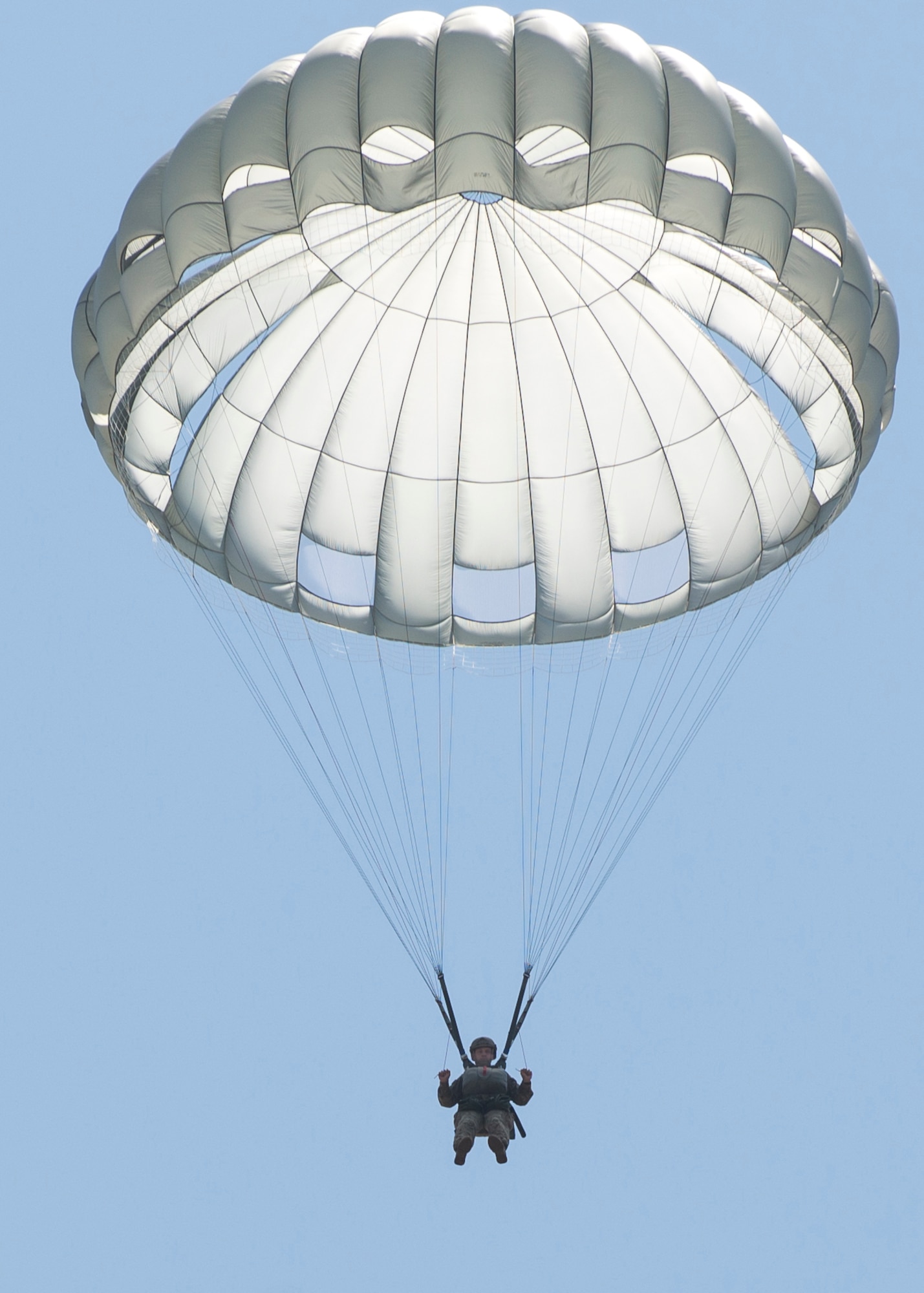 A U.S. Air Force Airman assigned to the 93d Air Ground Operations Wing drifts through the sky, June 17, 2016, at the Lee Fulp drop zone in Tifton, Ga. Jumpers were able to steer themselves safely to the ground using the MC-6 parachute. (U.S. Air Force photo by Airman Daniel Snider/Released)