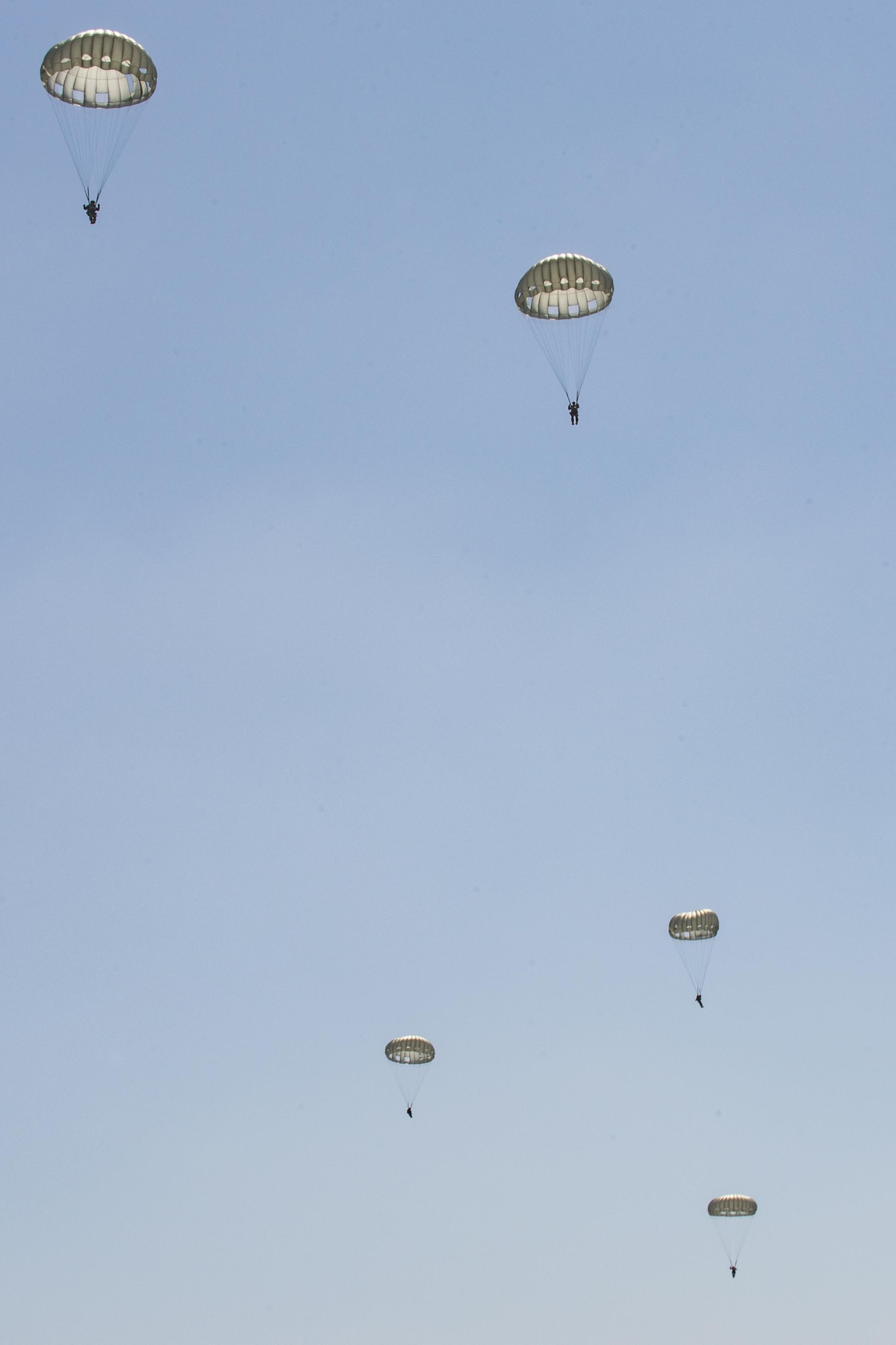 U.S. Air Force Airmen assigned to the 93d Air Ground Operations Wing glide through the sky, June 17, 2016, at the Lee Fulp drop zone in Tifton, Ga. In the event that two Airmen collide, they’re trained to “starfish” their bodies to prevent tangling in each other’s parachute. (U.S. Air Force photo by Airman Daniel Snider/Released)
