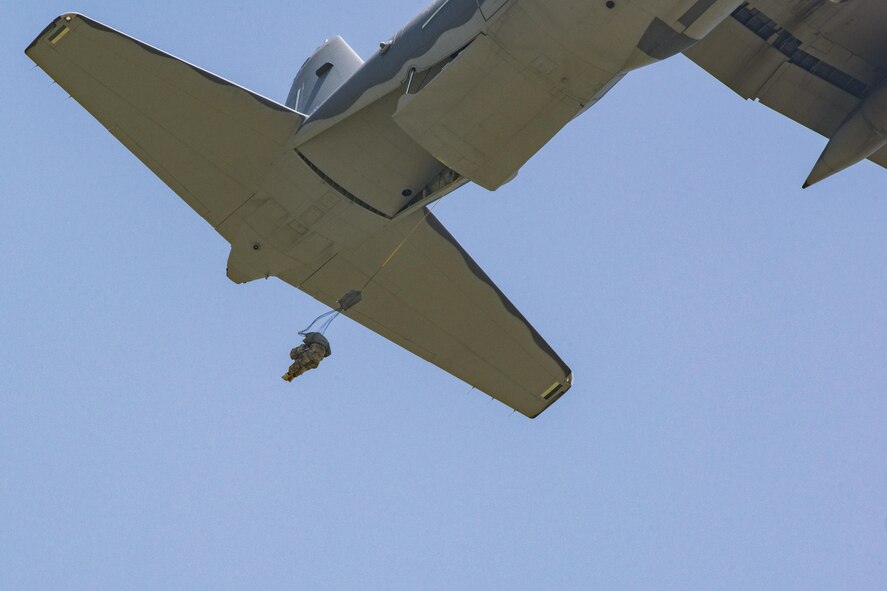 A U.S. Air Force Airman assigned to the 93d Air Ground Operations Wing exits the back of an HC-130J Combat King II, June 17, 2016, at the Lee Fulp drop zone in Tifton, Ga. The Airmen’s parachutes deployed using a static line as they jumped from the aircraft. (U.S. Air Force photo by Airman Daniel Snider/Released)