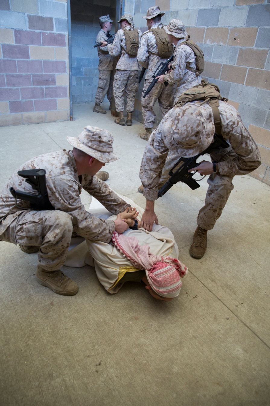 Marines with 4th Law Enforcement Battalion, Force Headquarters Group, Marine Forces Reserve, practice detaining procedures during a room clearing exercise at the Muscatatuck Urban Training Center in Butlerville, Ind., June 9, 2016. The Marines worked in teams to effectively search different rooms and apprehend any enemy forces they encountered.  (U.S. Marine Corps photo by Lance Cpl. Melissa Martens/ Released)