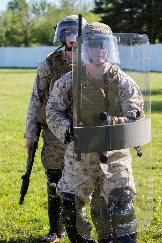 Lance Cpl. Clayton M. Bratten (front), a military policeman with 4th Law Enforcement Battalion, Force Headquarters Group, Marine Forces Reserve, and Cpl. Andy C. Ness (back), a military policeman with 4th Law Enforcement Battalion, practice different crowd and riot control methods at the Muscatatuck Urban Training Center in Butlerville, Ind., June 9, 2016. The Marines focused on non-lethal techniques that could be used to defeat the enemy and accomplish the mission. (U.S. Marine Corps photo by Lance Cpl. Melissa Martens/ Released)