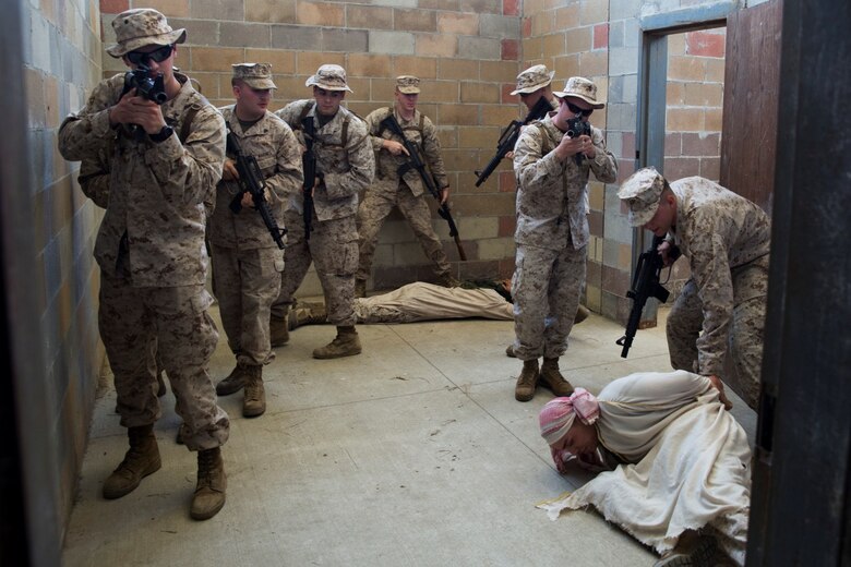 Marines with 4th Law Enforcement Battalion, Force Headquarters Group, Marine Forces Reserve, clear a room during their annual training at the Muscatatuck Urban Training Center in Butlerville, Ind., June 9, 2016. The Marines worked in teams to effectively search different rooms and apprehend any enemy forces they encountered.  (U.S. Marine Corps photo by Lance Cpl. Melissa Martens/ Released)