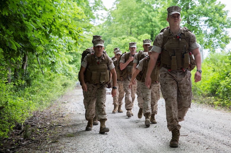 Capt. James M. Kenney-Prentiss (front), battalion adjutant with 6th Communications Battalion, Force Headquarters Group, Marine Forces Reserve, leads his Marines on a hike through the trails at the Muscatatuck Urban Training Center in Butlerville, Ind., June 10, 2016. The Marines battled hills and weather conditions during the hike and pushed each other to finish strongly. (U.S. Marine Corps photo by Lance Cpl. Melissa Martens/ Released)