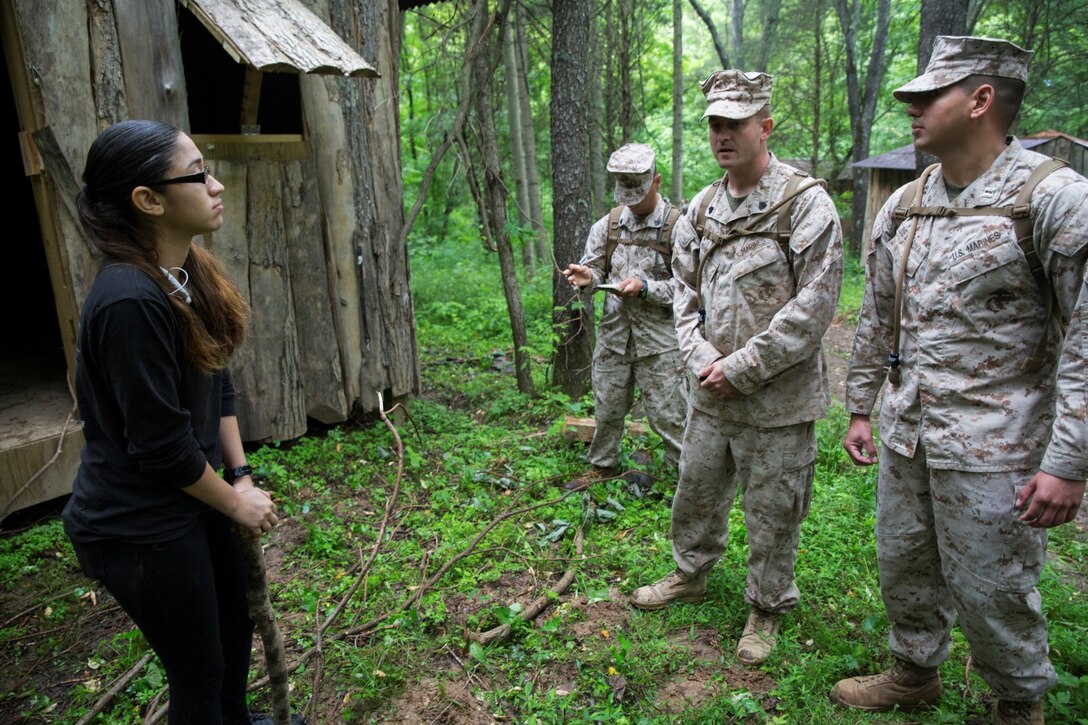 Lance Cpl. Cindy C. Vargas (left), administration specialist with 4th Civil Affairs Group, Force Headquarters Group, Marine Forces Reserve, acts as the head of water treatment for a local village, while Marines with 1st Civil Affairs Group, Force Headquarters Group, Marine Forces Reserve, practice problem solving methods at the Muscatatuck Urban Training Center in Butlerville, Ind., June 10, 2016. The Marines worked as a team to communicate with members of the village and ensure them their needs will be taken care of. (U.S. Marine Corps photo by Lance Cpl. Melissa Martens/ Released)