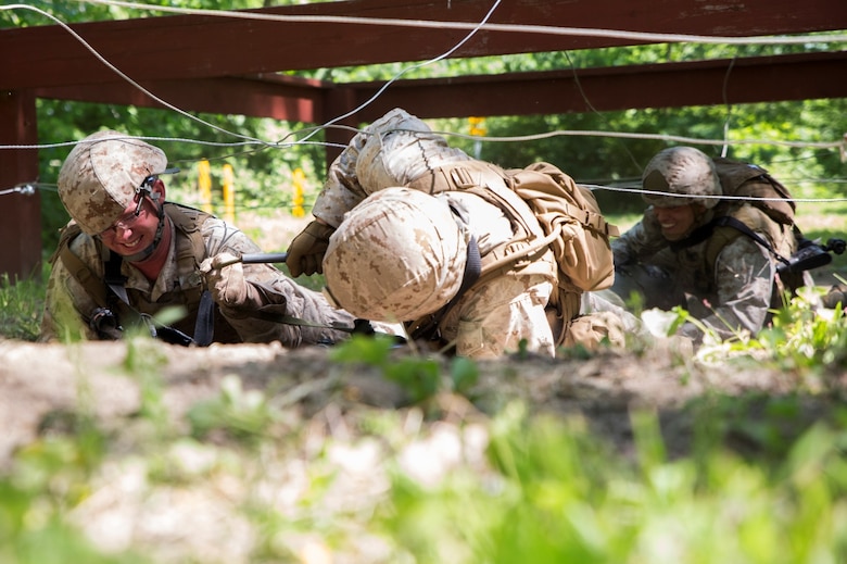 Marines with 3rd, 4th and 6th Air Naval Gunfire Liaison Company, Force Headquarters Group, Marine Forces Reserve, run through a litter course during ANGLICO Basic Course Training at Camp Atterbury, Ind., June 13, 2016. The Marines took contact from enemy forces while clearing a building, which left them with a causality. They had to complete a course full of obstacles while bringing the causality to the safety helicopter.  (U.S. Marine Corps photo by Lance Cpl. Melissa Martens/ Released)