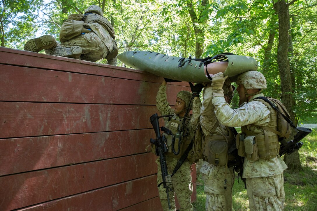Marines with 3rd, 4th and 6th Air Naval Gunfire Liaison Company, Force Headquarters Group, Marine Forces Reserve, run through a litter course during ANGLICO Basic Course Training at Camp Atterbury, Ind., June 13, 2016. The Marines took contact from enemy forces while clearing a building, which left them with a casualty. They had to complete a course full of obstacles while bringing the causality to the safety helicopter.  (U.S. Marine Corps photo by Lance Cpl. Melissa Martens/ Released)