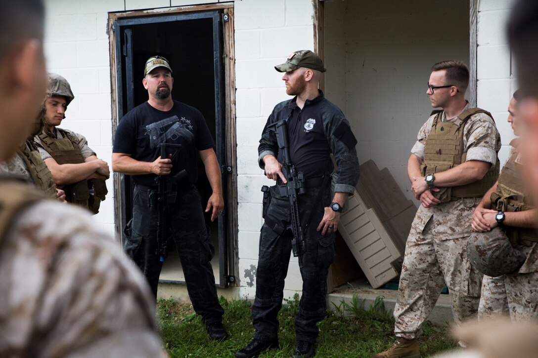Marines with 6th Communications Battalion, Force Headquarters Group, Marine Forces Reserve, receive a building clearing class from the Evansville, Ind., Special Weapons and Tactics team at the Muscatatuck Urban Training Center in Butlerville, Ind., June 14, 2016. The Marines were taught how to safely and effectively clear buildings and properly handle their weapons. (U.S. Marine Corps photo by Lance Cpl. Melissa Martens/ Released)