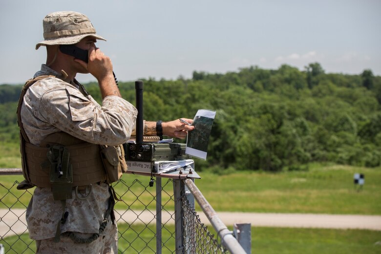 Staff Sgt. Theodore K. Pernal, radio chief with 4th Air Naval Gunfire Liaison Company, Force Headquarters Group, Marine Forces Reserve, calls in the coordinates for an air strike at Camp Atterbury, Ind., June 15, 2016. Pernal worked with a team of Marines to gather information throughout the mission so he could relay the correct coordinates to ensure the target was hit. (U.S. Marine Corps photo by Lance Cpl. Melissa Martens/ Released) 
