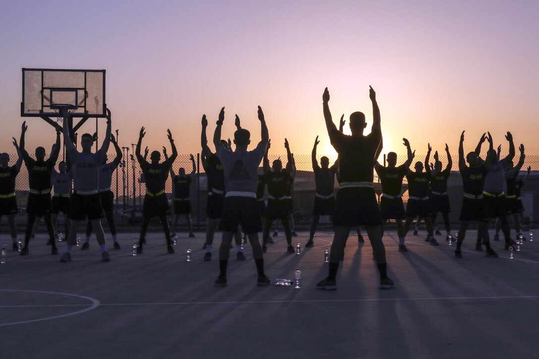 Soldiers stretch during sunrise before an early morning run at Camp Arifjan, Kuwait, June 13, 2016. Army photo by Sgt. Brandon Hubbard