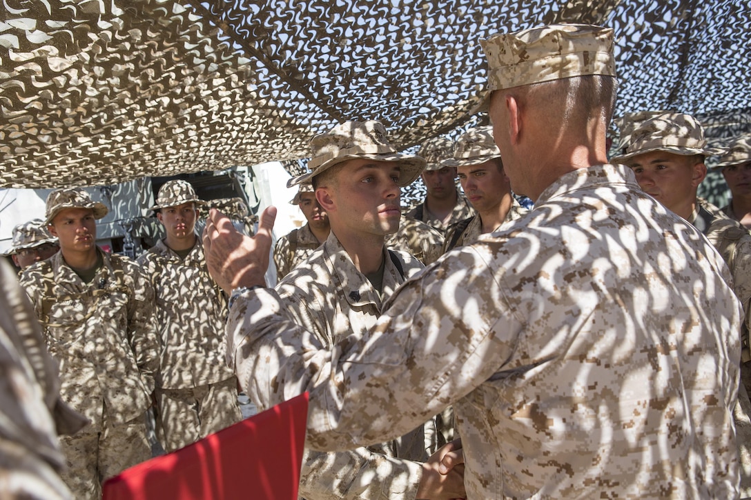 Sgt. Joshua F. Stark, a motor transport operator with Combat Logistics Battalion 25, 4th Marine Logistics Group, Marine Forces Reserve, receives a Navy and Marine Corps Achievement Medal from Lt. Gen. Rex C. McMillian, commander of Marine Forces Reserve, for displaying exceptional leadership qualities and initiative that earned him Reserve Component Noncommissioned Officer of the Year, while attending Integrated Training Exercise 4-16 aboard Marine Corps Air Ground Combat Center Twentynine Palms, Calif., June 19, 2016. During the annual training period, the Marines train to perfect their techniques, tactics and procedures to ensure they are ready to deploy worldwide.