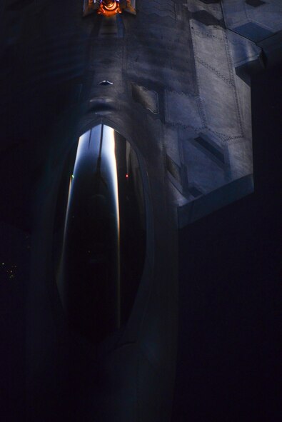 An F-22 Raptor, assigned to the 433rd Weapons Squadron, Nellis Air Force Base, Nev., flies as it is refueled in-air during Deliberate Strike Night over the Nevada Test and Training Range, June 16, 2016. DSN fits into the bigger picture of the Advanced Integration portion of the weapons school curriculum by testing stealth and conventional airframes abilities to conduct attacks during the hours after the sun sets.  (U.S. Air Force photo by Airman 1st Class Kevin Tanenbaum)