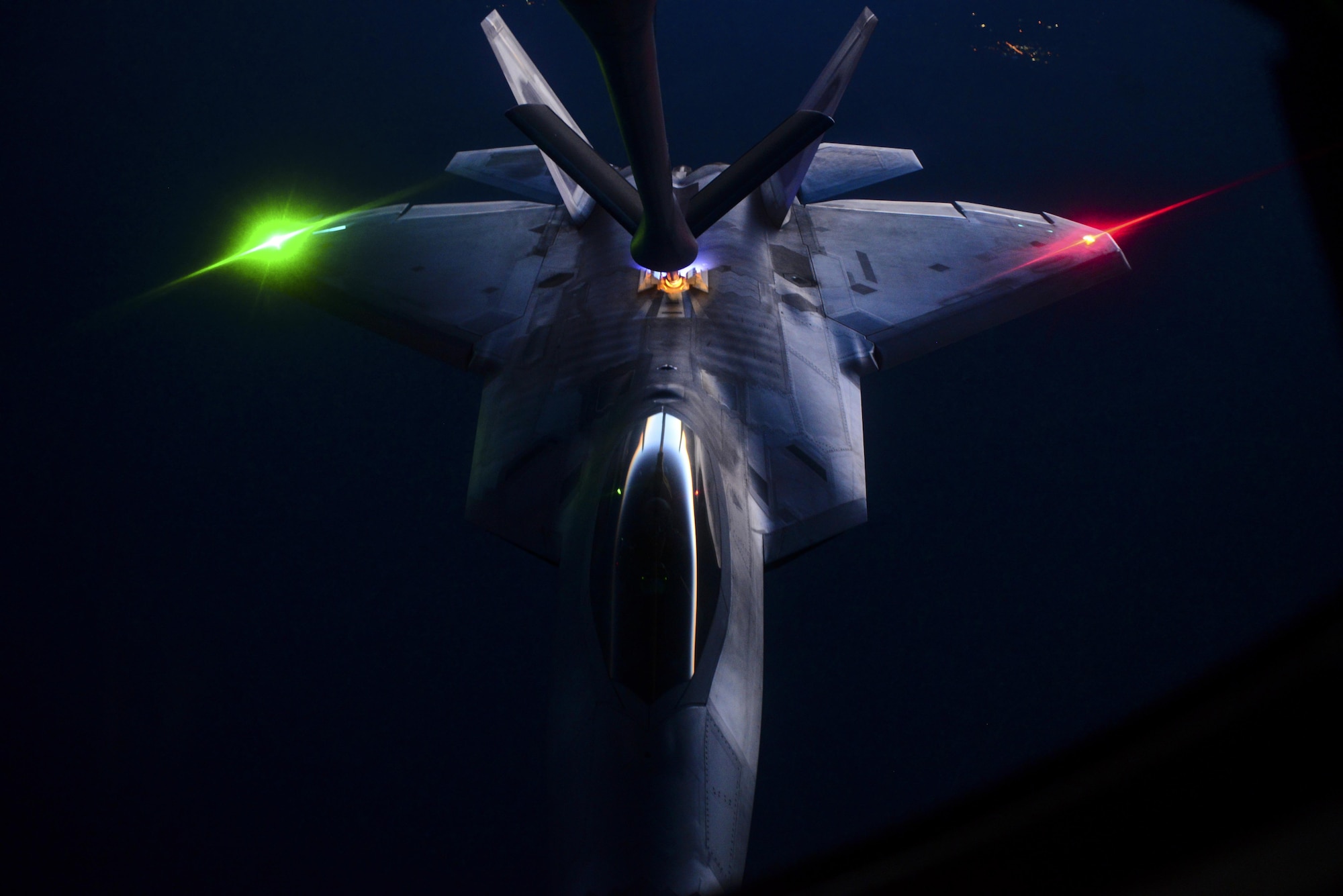 A KC-135, assigned to the 509th Weapons Squadron, Fairchild Air Force Base, Wash., preforms aerial refueling on an F-22 Raptor, assigned to the 433rd Weapons Squadron, Nellis Air Force Base, Nev., over the Nevada Test and Training Range during the United States Air Force Weapons School’s Deliberate Strike Night, June 16, 2016. DSN is part of the final seven day Advanced Integration portion of the Weapons School curriculum; testing stealth and conventional airframes abilities to conduct attacks during the hours after the sun sets. (U.S. Air Force photo by Airman 1st Class Kevin Tanenbaum)