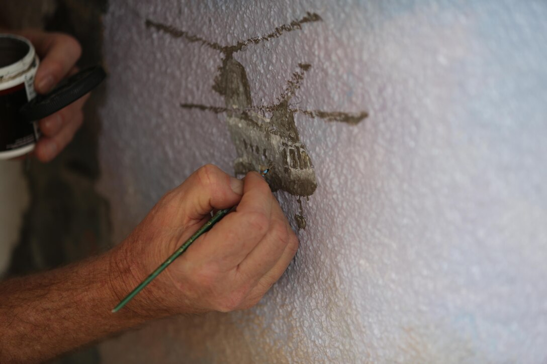 Artist Richard DeRosset, a La Jolla, Calif., native and a Navy veteran, paints a CH-46 Sea Knight on a mural located at the Airmen and Marine Memorial Chapel aboard Marine Corps Air Station Miramar, Calif., May 10. DeRosset painted the mural as a part of the War on Terrorism Memorial at the chapel. (U.S. Marine Corps photo by Pfc. Liah Kitchen/Released)