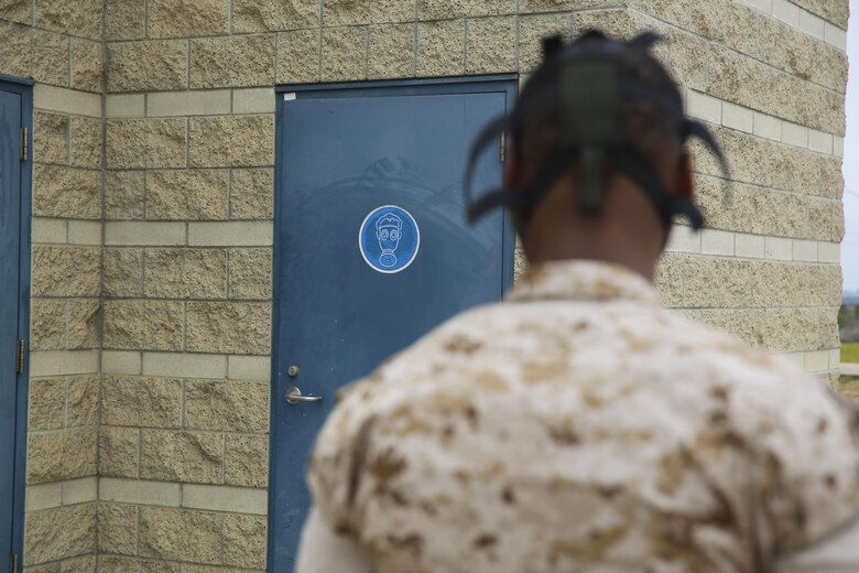 A military police officer with the Provost Marshal’s Office guards the door to the gas chamber during a Chemical, Biological, Radiological, Nuclear and High-Yield Explosives (CBRNE) exercise aboard Marine Corps Air Station Miramar, Calif., May 18. The exercise revolved around the PMO, Miramar Fire Department, Explosive Ordnance Disposal, and Aircraft Rescue and Firefighting working together to identify and eliminate the threat of a simulated clandestine drug lab. (U.S. Marine Corps photo by Cpl. Alissa Schuning/Released)